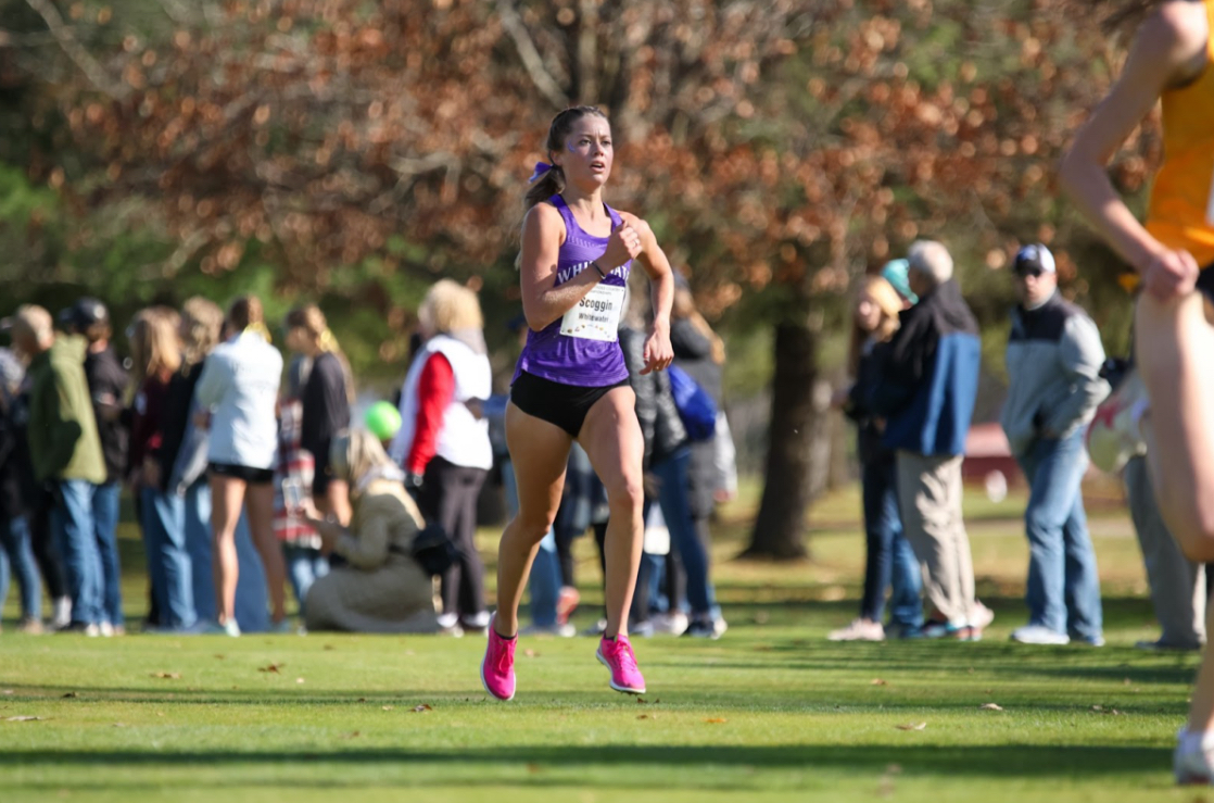 Junior runner Payton Scoggin running at the WIAC Championships in Stevens Point. Scoggin finished 16th in the meet with a time of 22:10.8, a new personal record for her.
