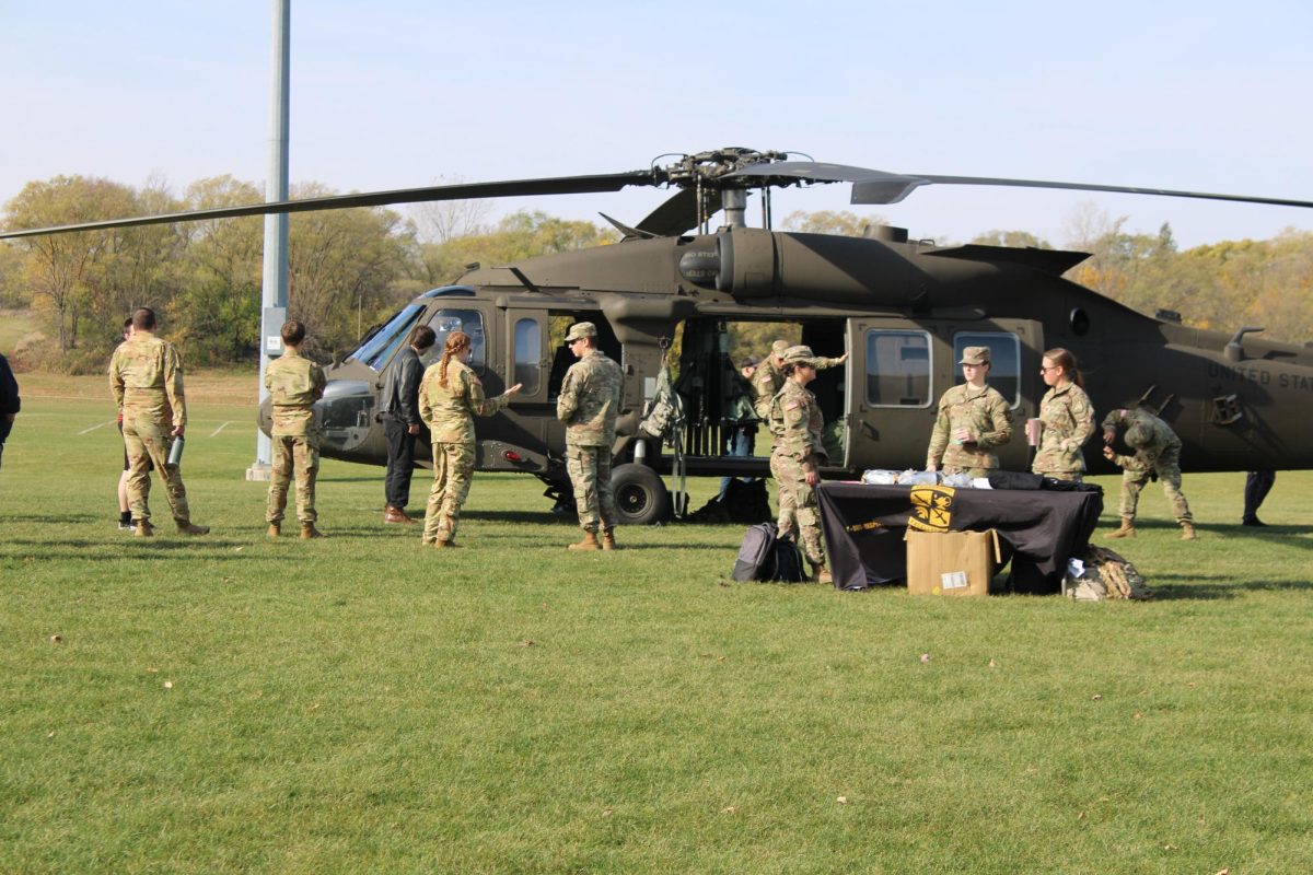 ROTC members man a table with information about their organization in front of the helicopter, October 29th, 2024. 