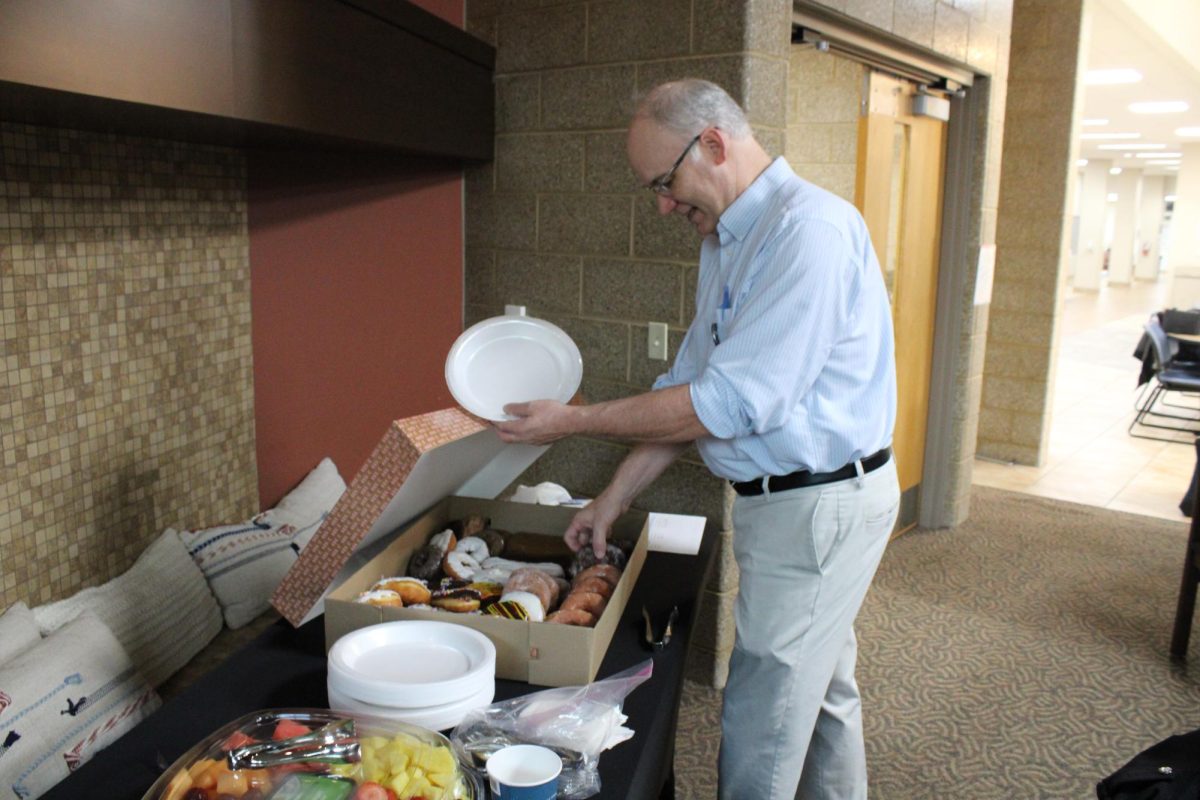 Biology Professor Tom Klubertanz grabbing donuts