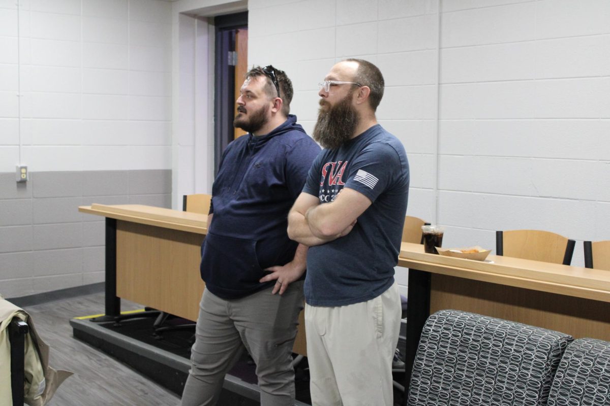 Veteran Coordinator Kris McMenamin stands with Navy Veteran Mark Zimmermann, watching the bowling match. Nov 12 2024. 