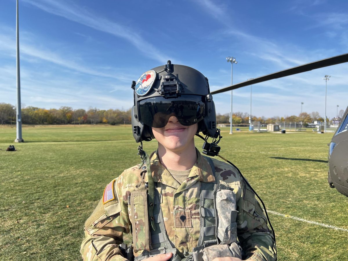 Spc. George Smith wearing an aircraft helmet