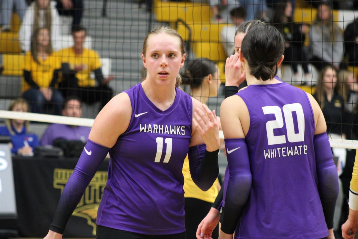 Graduate student outside hitter Alayna Janksy (11) talking things over with junior outside hitter Chloe Werner (20) in the WIAC Championship. Jansky transferred to UW-Whitewater for her final year after playing a majority of her collegiate career for Division I schools Eastern Michigan and Winthrop.