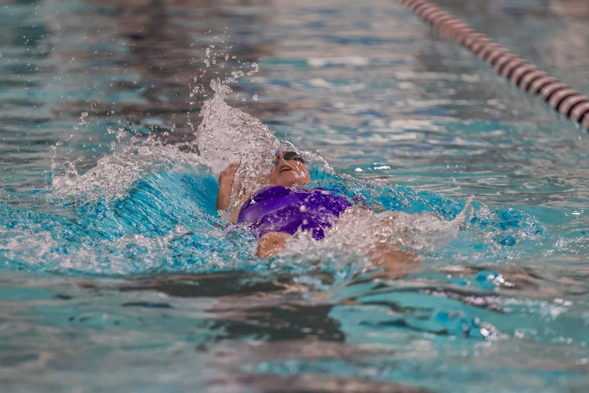 Izzy Doczy doing a backstroke at the Luther Invitational, November 23-24, 2024.