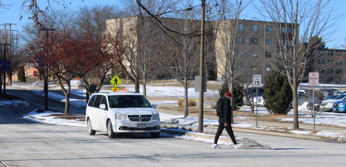 Pedestrian crosses updated crosswalk on Starin road Sunday before classes, January 26, 2025.