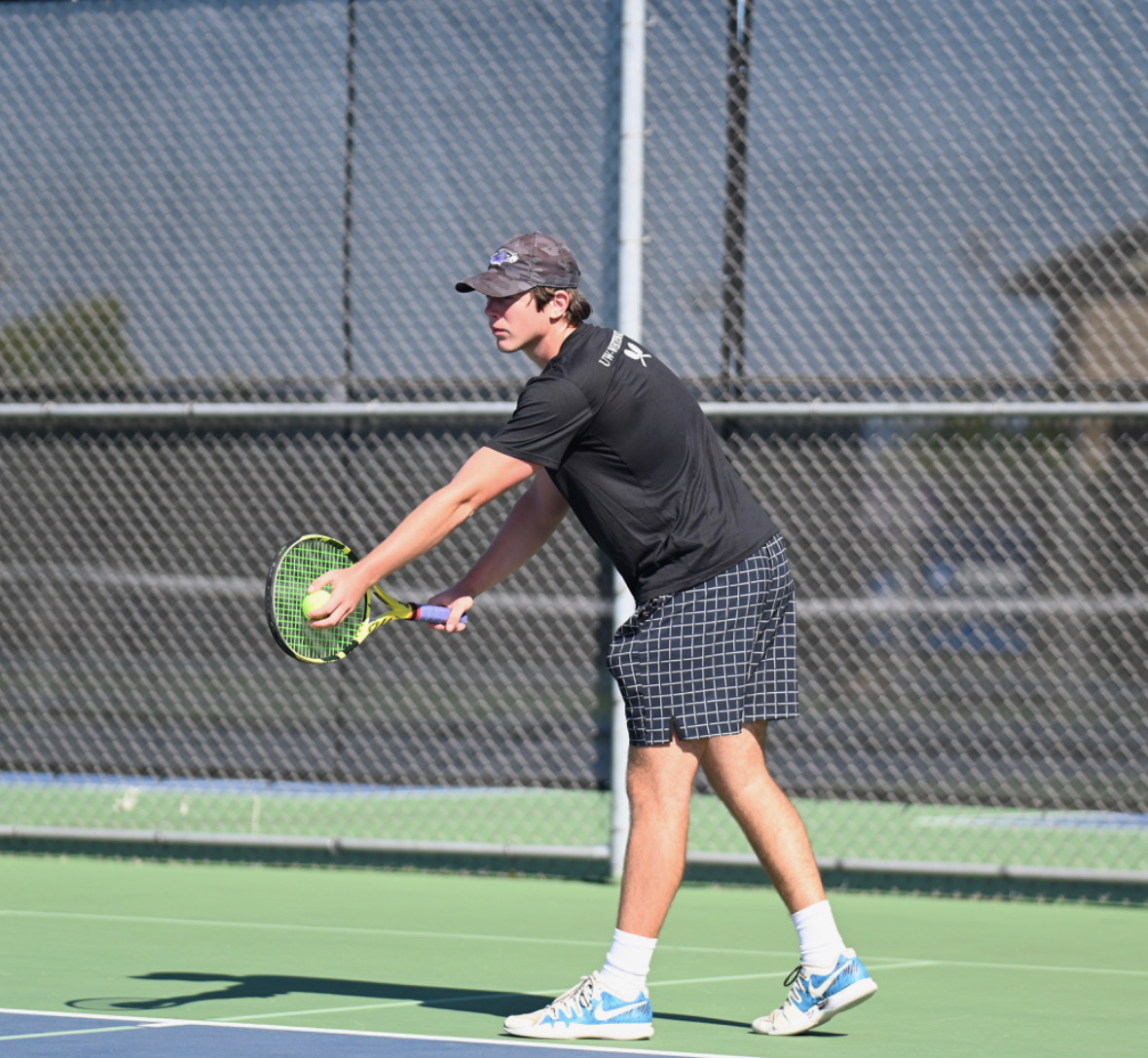 Junior, Sprague gets ready to serve the ball against an opponent in a tennis match at UW-Whitewater’s home tennis courts.