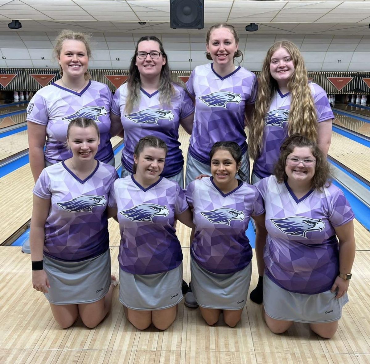 Grace Lehmann (top left-center) poses with the rest of her team.