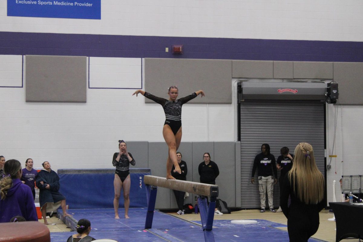 Farrah Hutchenson maintains her balance on the balance beam against UW-Oshkosh in the Kris Russell Volleyball Arena, Feb. 15, 2025.