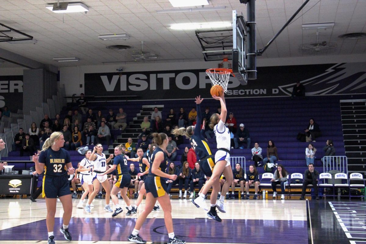 Senior Maggie Trautsch drives past Eau Claire defenses and completes a two point basket at the Senior Night home game on February 22, 2025.