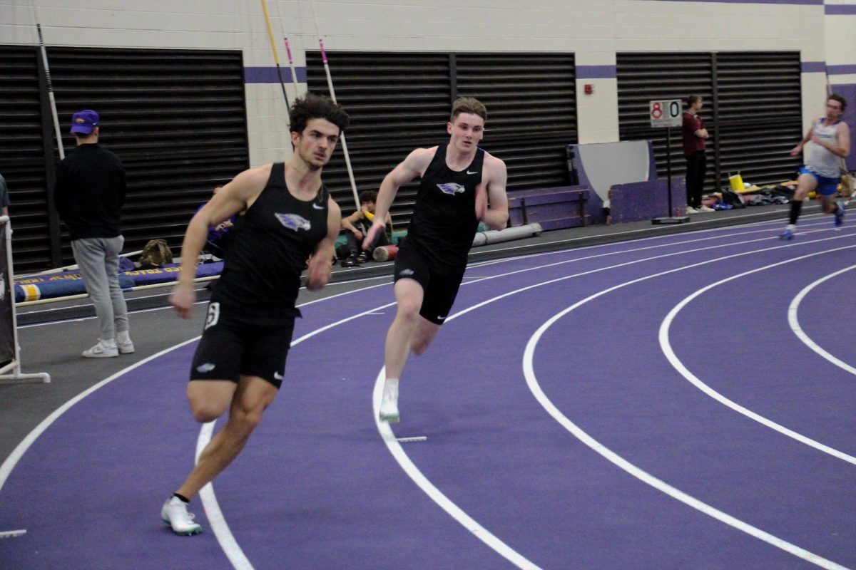 Juniors Brad Heller and Chris Kalies race against each other in neighboring lanes in the men’s 400 meter dash at the Squig Conference Meet, January 31, 2024.