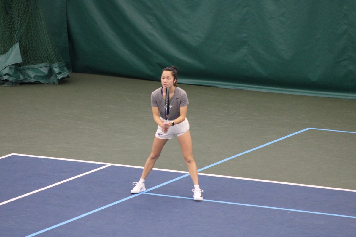 Gracie Ha anticipates the ball's return to her side of the tennis court.