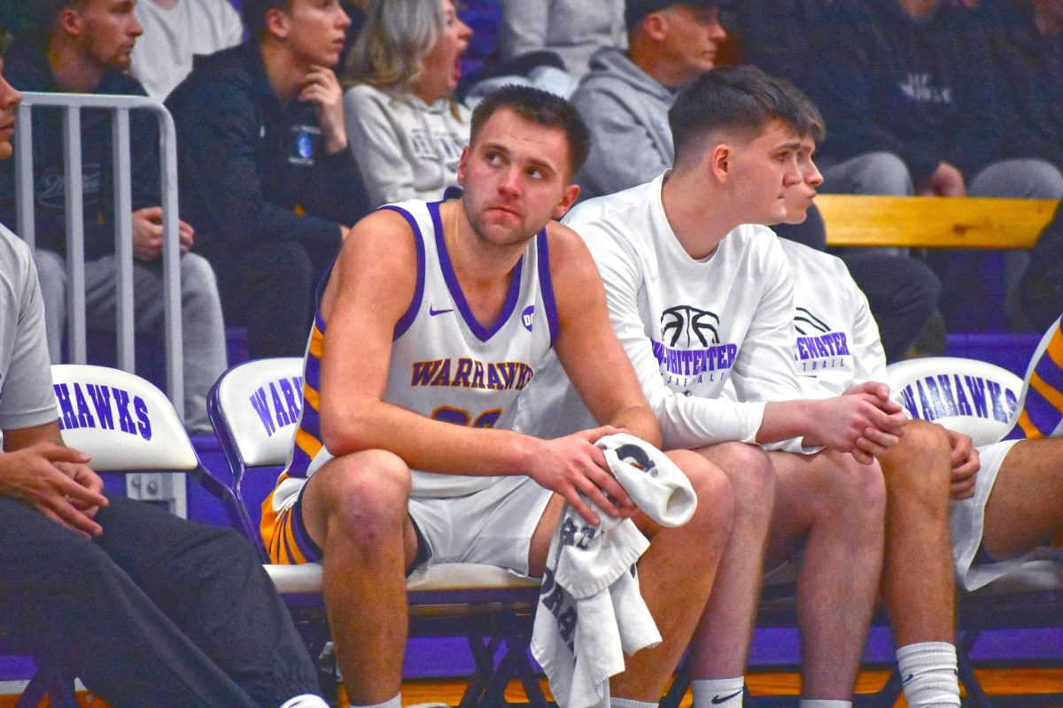 Senior forward Carter Capstran sits on the bench after being subbed out for the last time on his home court, Kachel Gymnasium Feb. 19.