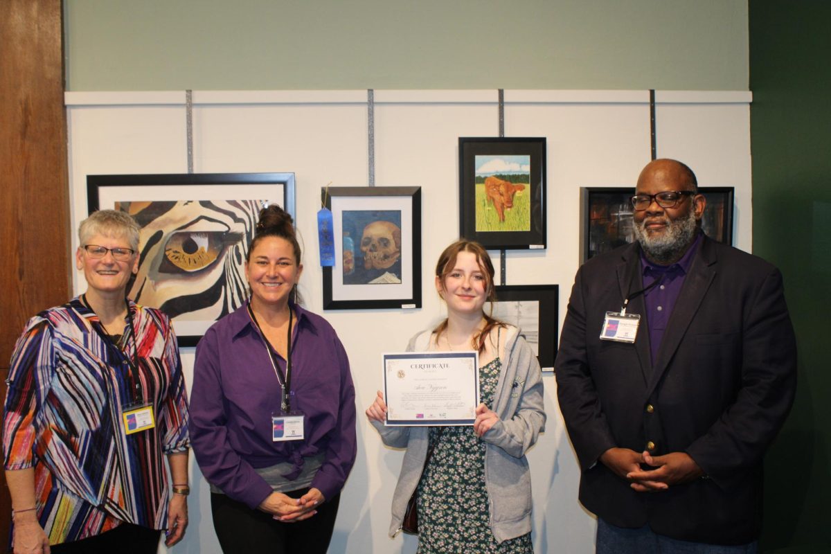 Ava, shown in previous photographs, stands to several important members of the Art Alliance. From left to right are Kim Adams, Camden Harlan, Ava Nygren, and Dwight Watson, April 26, 2025.