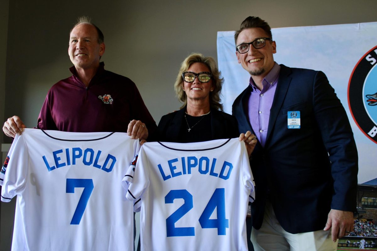Lance and Kelly Leipold receive honorary jerseys from the Beloit Sky Carp, posing with team president Zach Brockman at ABC Supply Stadium in Beloit May 9.