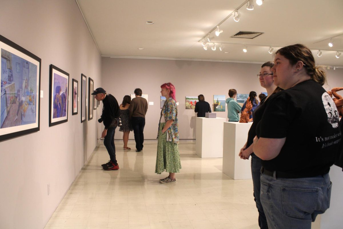 UW-Whitewater students and guests take a look at eye-catching art pieces created by UW-Whitewater senior fine art students at the BFA Senior Exhibition reception in UW-Whitewater's Crossman Gallery April 29 2025.