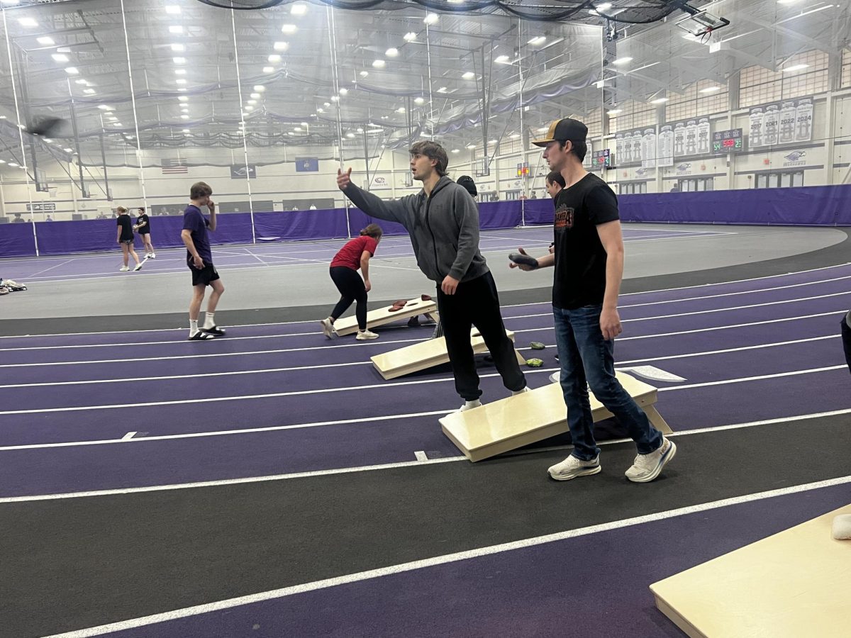 Cornhole club members warming up