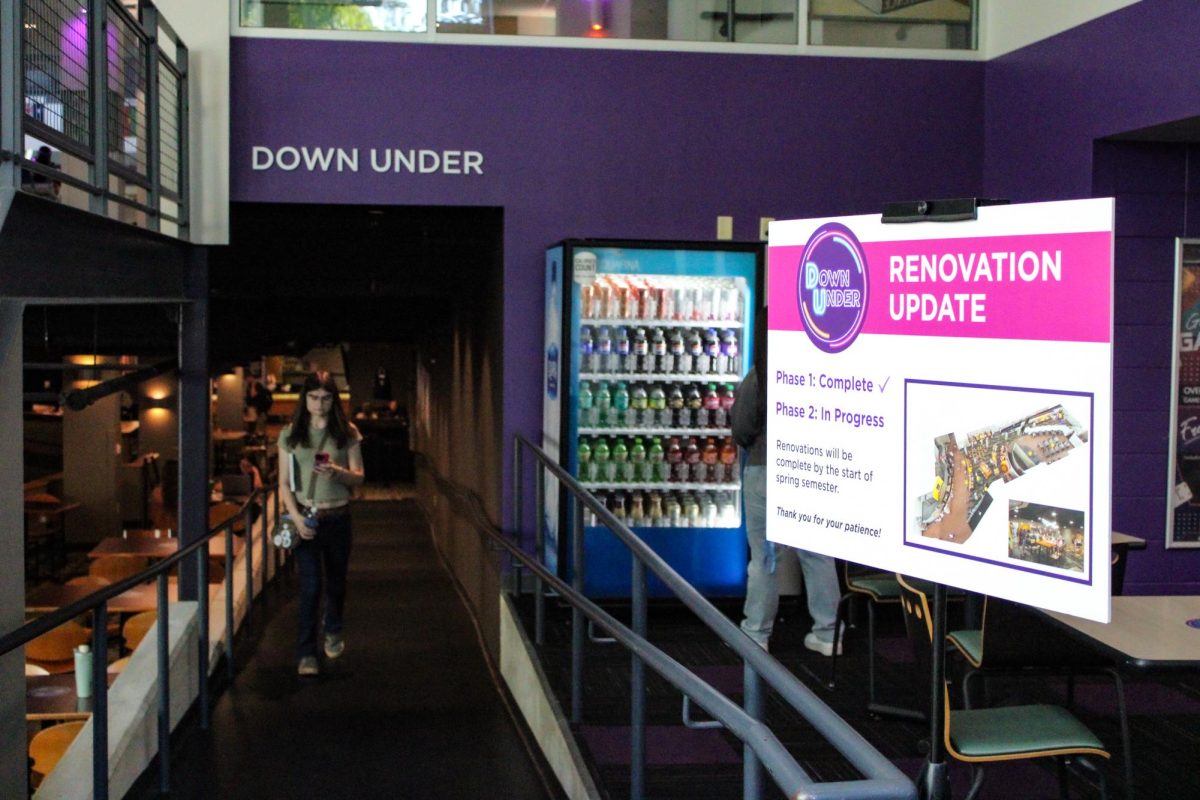 A UW-Whitewater student walks under the Down Under sign near a posted renovation update in the University Center on September 16th, 2025. 