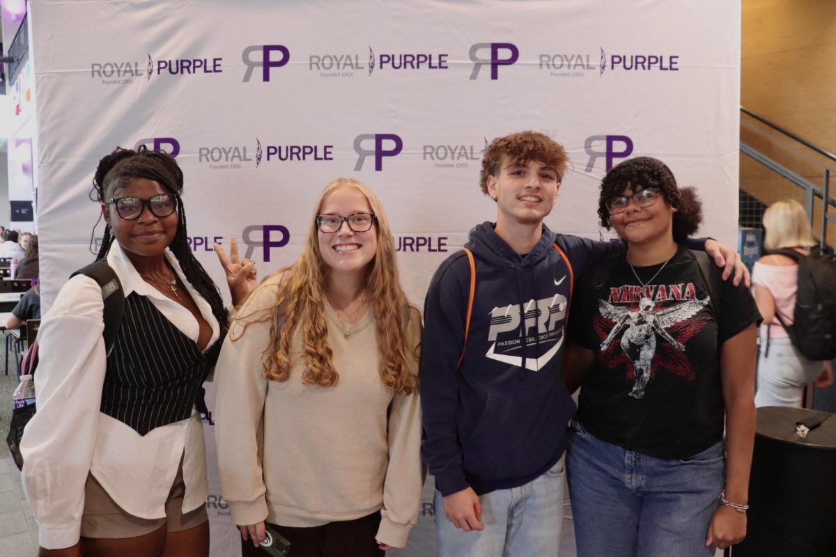A group of students pose for a photo at the Royal Purple booth in the Fall 2025 Involvement Fair, Wednesday Sept. 10 at UW-Whitewater.