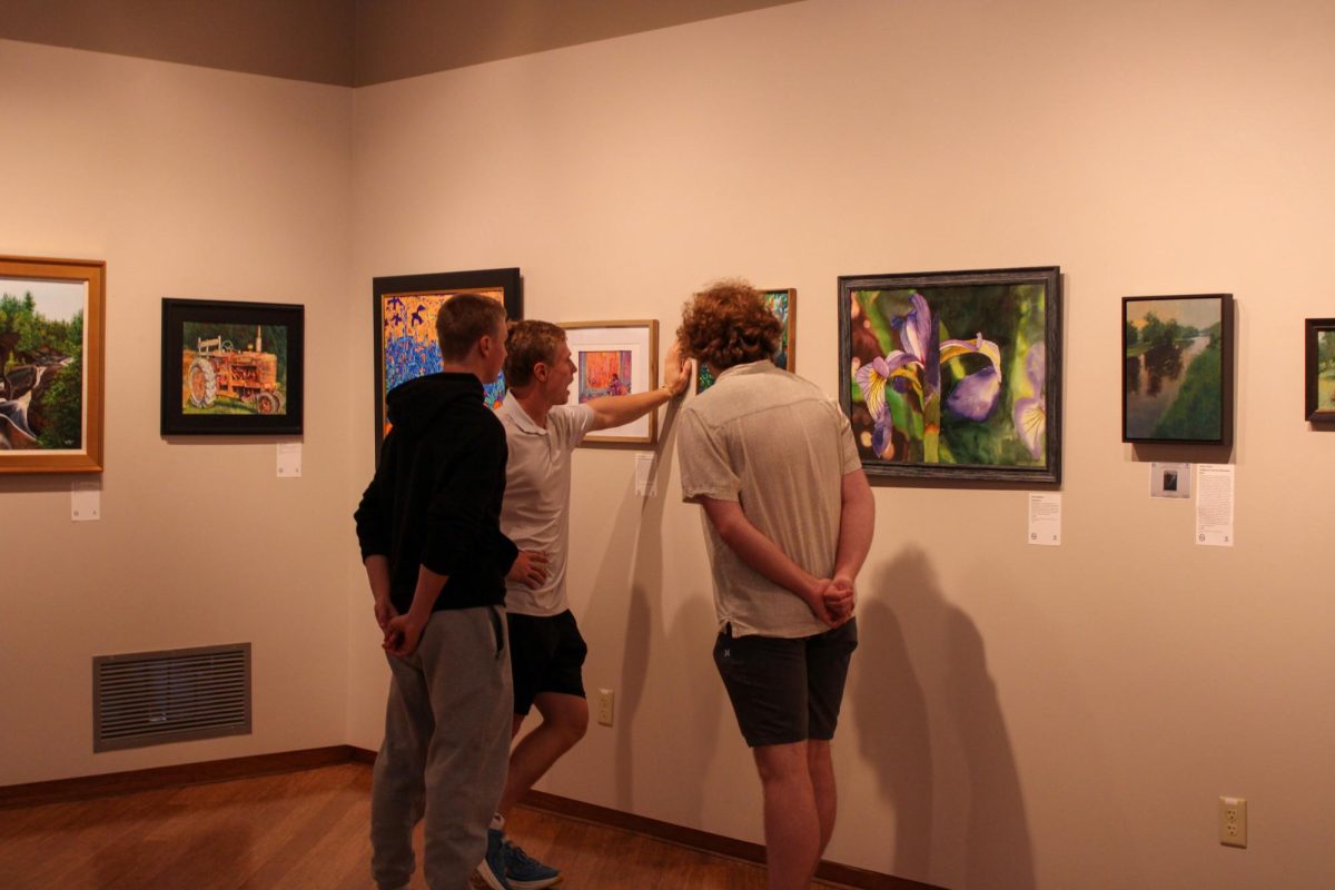 Freshman Roland Buchholz brought a group of friends to see his mom, Holly Buchholz's art piece “Lush In The City,” being displayed at the UC’s Roberta's Art Gallery on Aug. 29, 2025.
