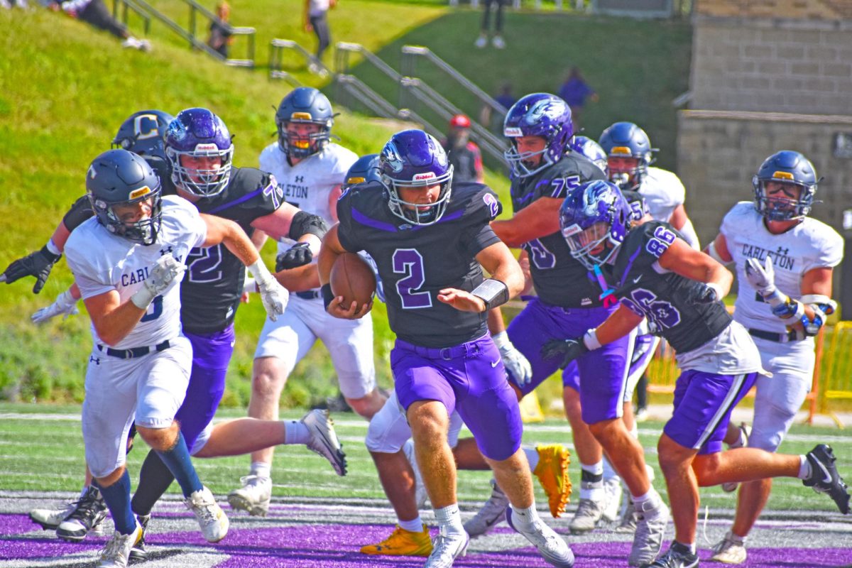 UW-Whitewater sophomore quarterback Justin Klinkner rushes past the Carleton defense to push towards a touchdown against Carleton College at Perkins Stadium on September 6th, 2025.