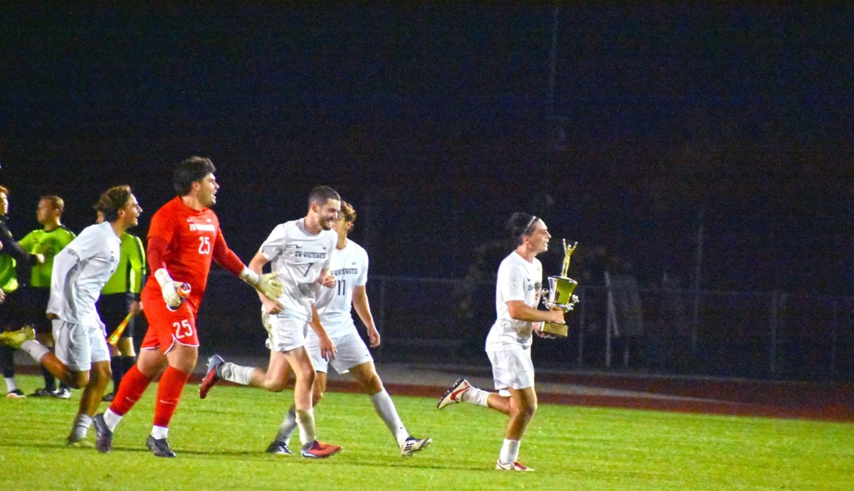  UW-Whitewater Men’s Soccer Team rushes towards the fans to celebrate their win with the Warhawk-Knight Cup after winning against Wartburg College on September 24th, 2025 at Fiskum Field.