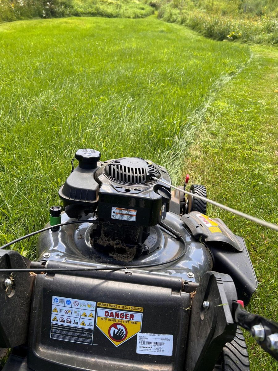 Chris Hardie uses a walk-behind mower to tackle several acres of lawn.