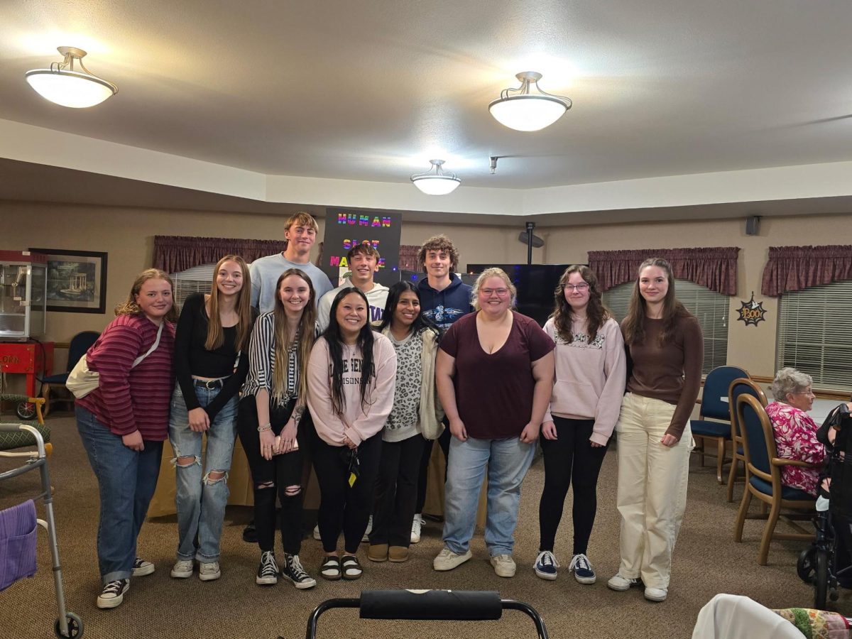 Students from the CORE 130 class pose for   a photo while meeting with residents. (Jeanette Davis)