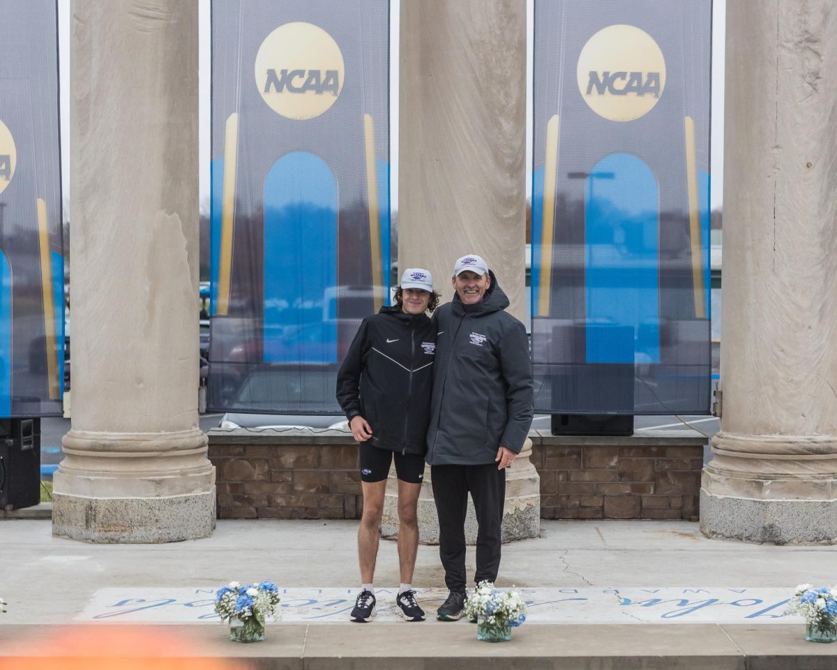 Gunner Schlender (left) and head coach Jeff Miller pose for a NCAA photo. Schlender graduated with a 4.0 GPA, was named the Elite 90 twice, and earned 12 All-American honors.