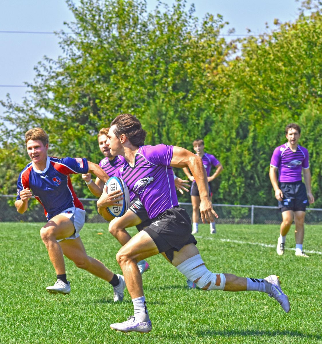 UW-Whitewater Club Rugby Antonio Brandt Garcia sprints past his opponent to advance the ball against UW-Stout on September 14th, 2025, at the Wisconsin Rugby Sports Complex.