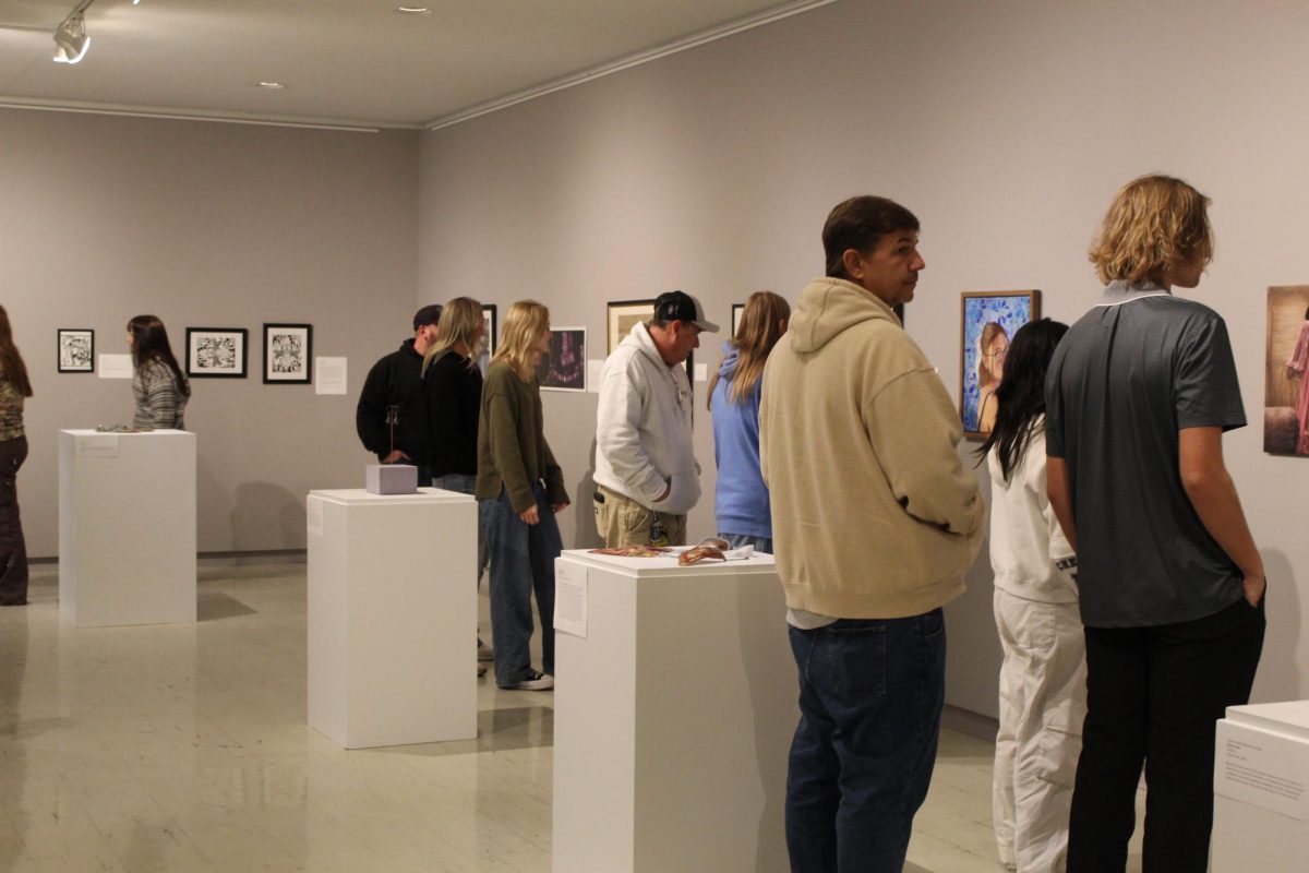Students and their families explore the Juried Student Art Exhibition at Crossman Gallery at the Greenhill Center of the Arts.