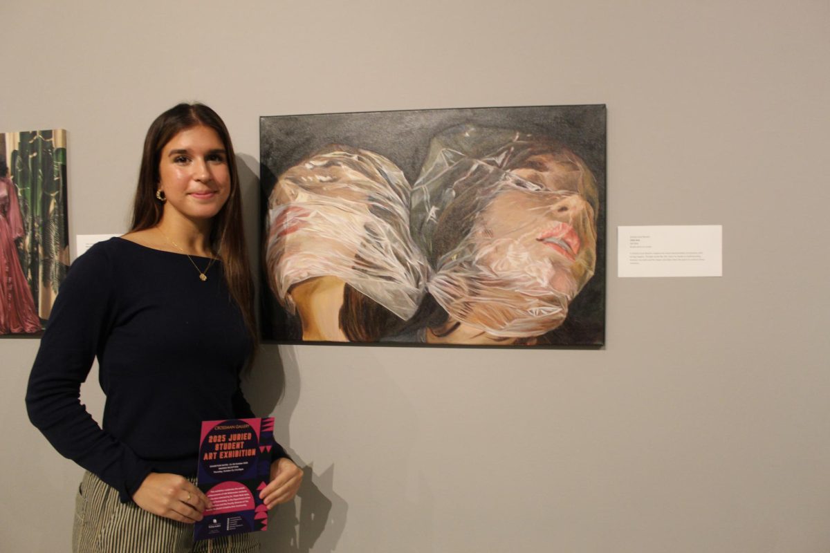  1st Place Winner, Lilli Rick, a junior here at UW-Whitewater stands proudly by her submitted piece at the Juried Student Art Exhibition at the Crossman Gallery at the Greenhill Center of the Arts. 
