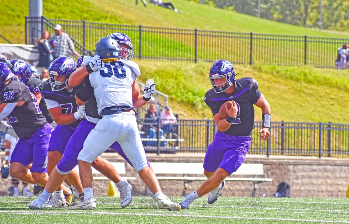 The UW-Whitewater sophomore quarterback Justin Klinkner rushes the ball towards the endzone on Sept. 4, 2025 against Carleton College at Perkins Stadium. 