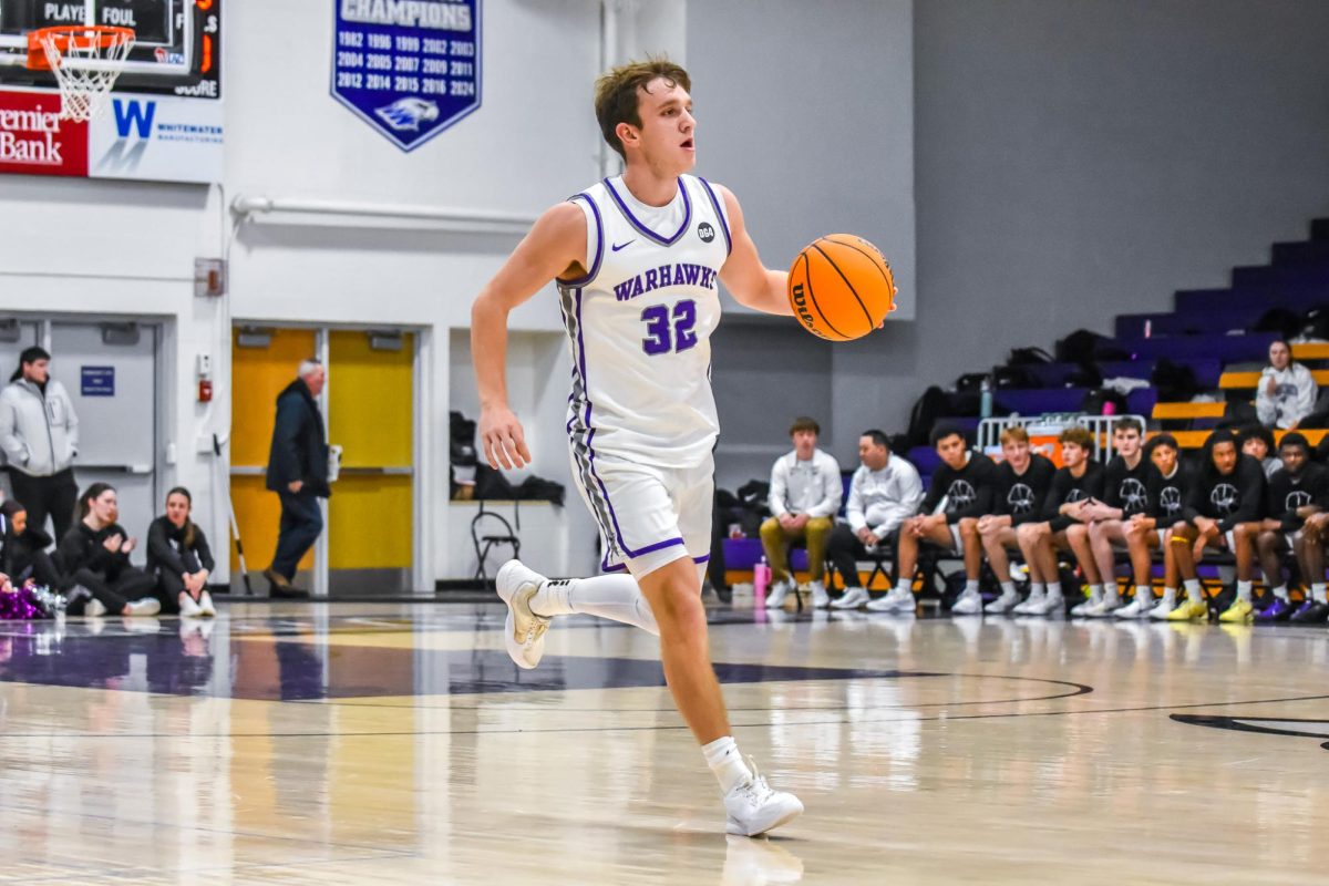 The UW-Whitewater senior guard Luke Bara dribbles the ball down the court to try to get a basket against Elmhurst University on Dec. 2, 2025 at the Kachel Gymnasium. 