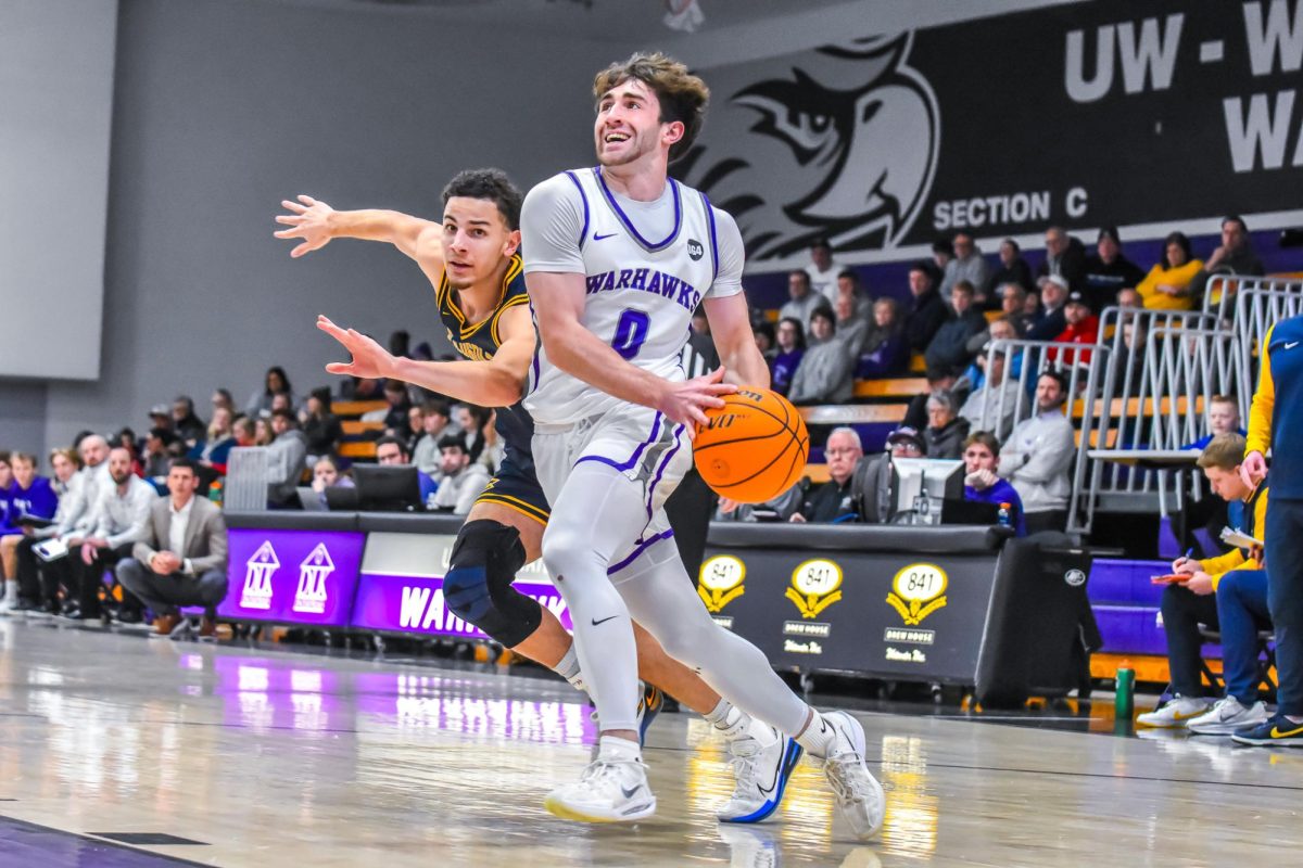 UW-Whitewater senior guard Isaac Verges dribbles the ball towards the basketball making a strong effort to get a basket while battling off UW-Eau Claire players in the Kachel Gymnasium Jan. 24, 2026.