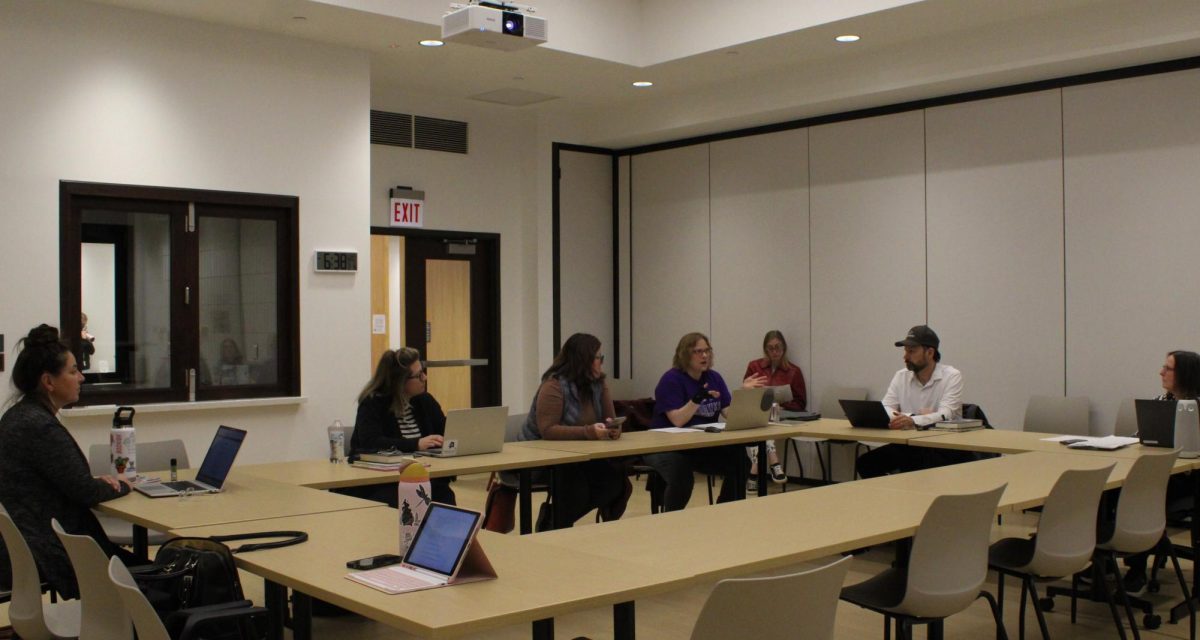 The library board members listen to Jennifer Motszko explains the new library explore passes.