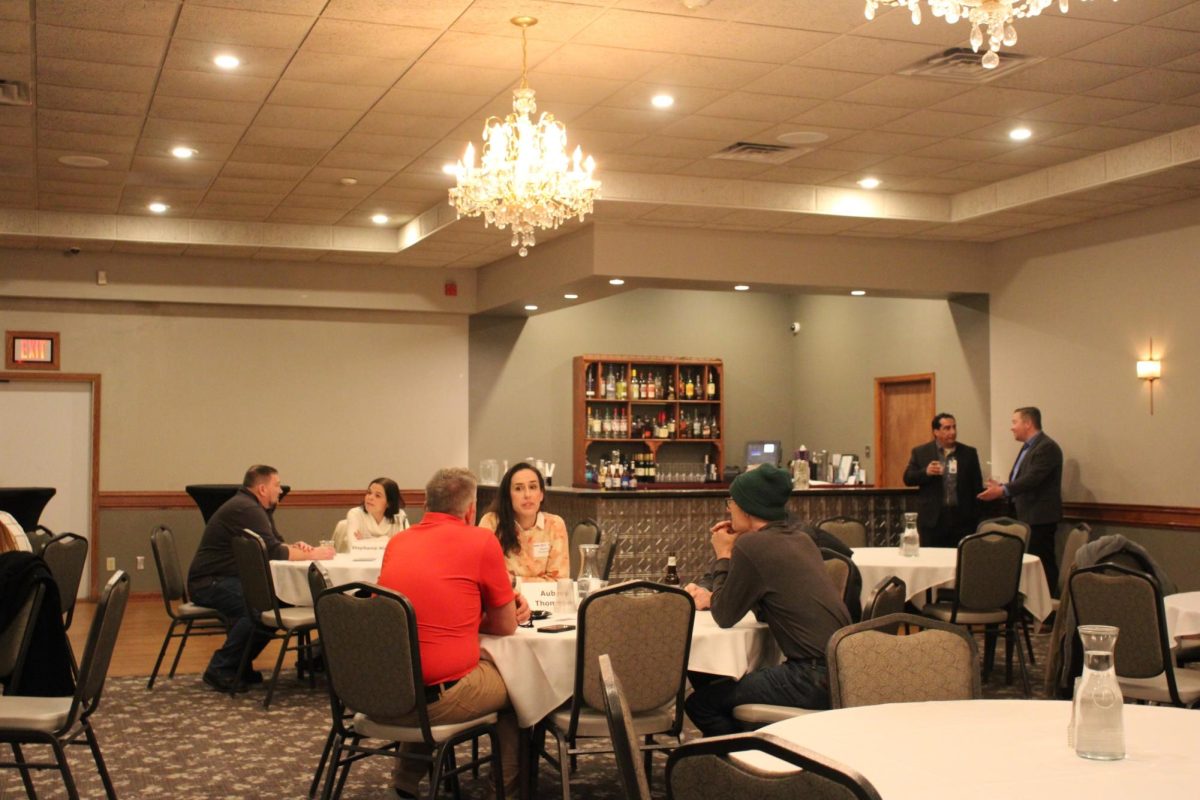 Aubrey Thompson speaks with community members at her table, Feb. 12, 2026.