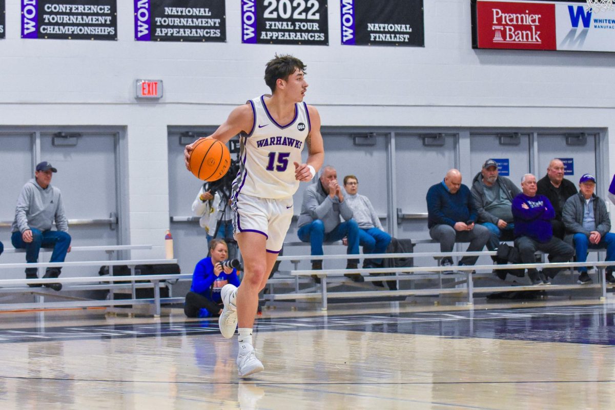  The UW-Whitewater Warhawk junior guard Collin Madson dribbles the ball down the court to try to score against UW-Platteville on Feb. 11, 2026 at the Kachel Gymnasium. 
