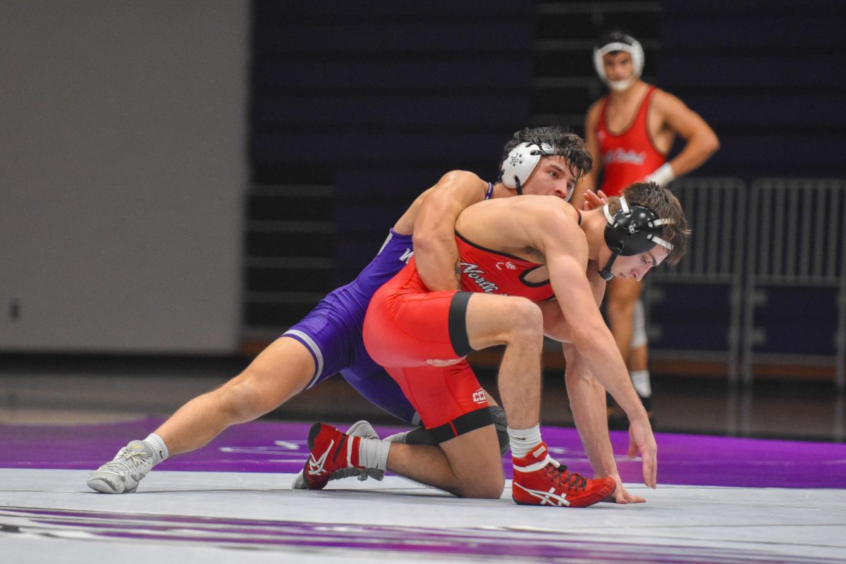 The UW-Whitewater Wrestling senior Warhawk Dominik Mallinder puts his opponent into a tight spot while trying to score points in the duel against North Central College in the Kachel Gymnasium, Nov. 15, 2026. 
