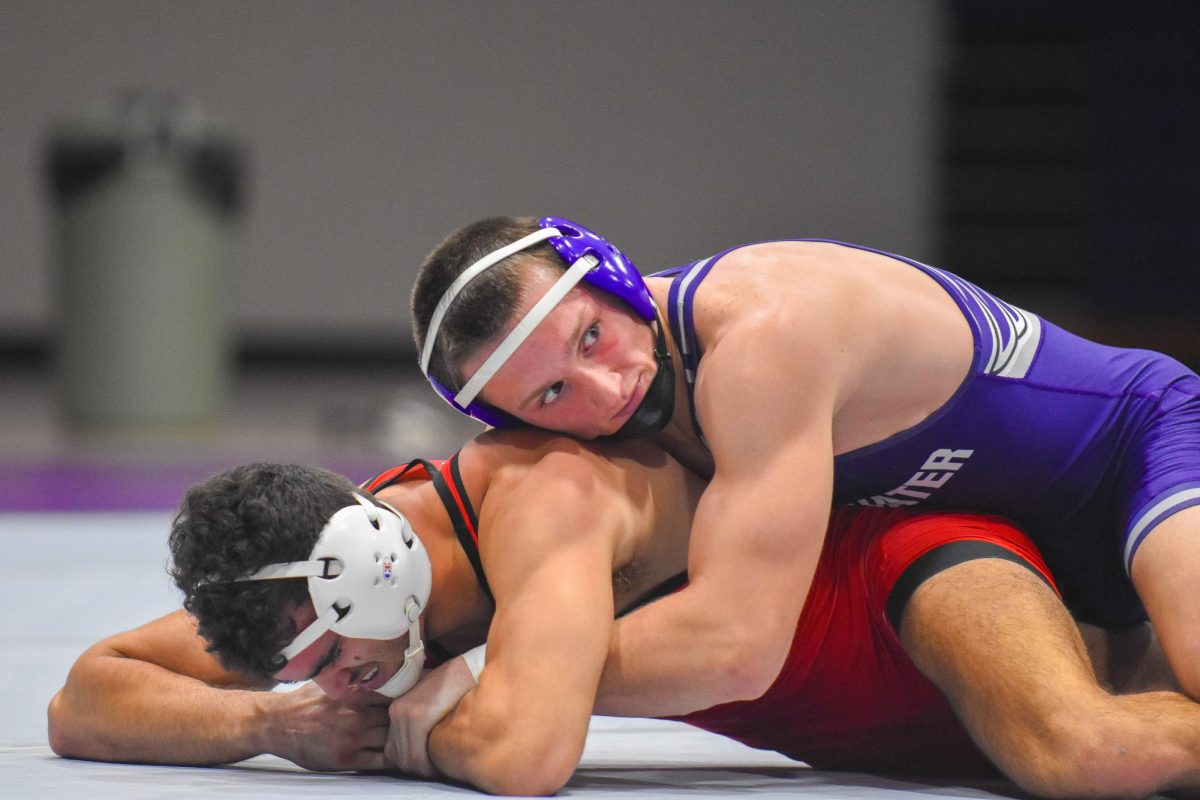 The UW-Whitewater Wrestler Warhawk junior Luke Swan looks at his coach as he has his opponent from North Central College on the ground at the Kachel Gymnasium on Nov. 15, 2025.

