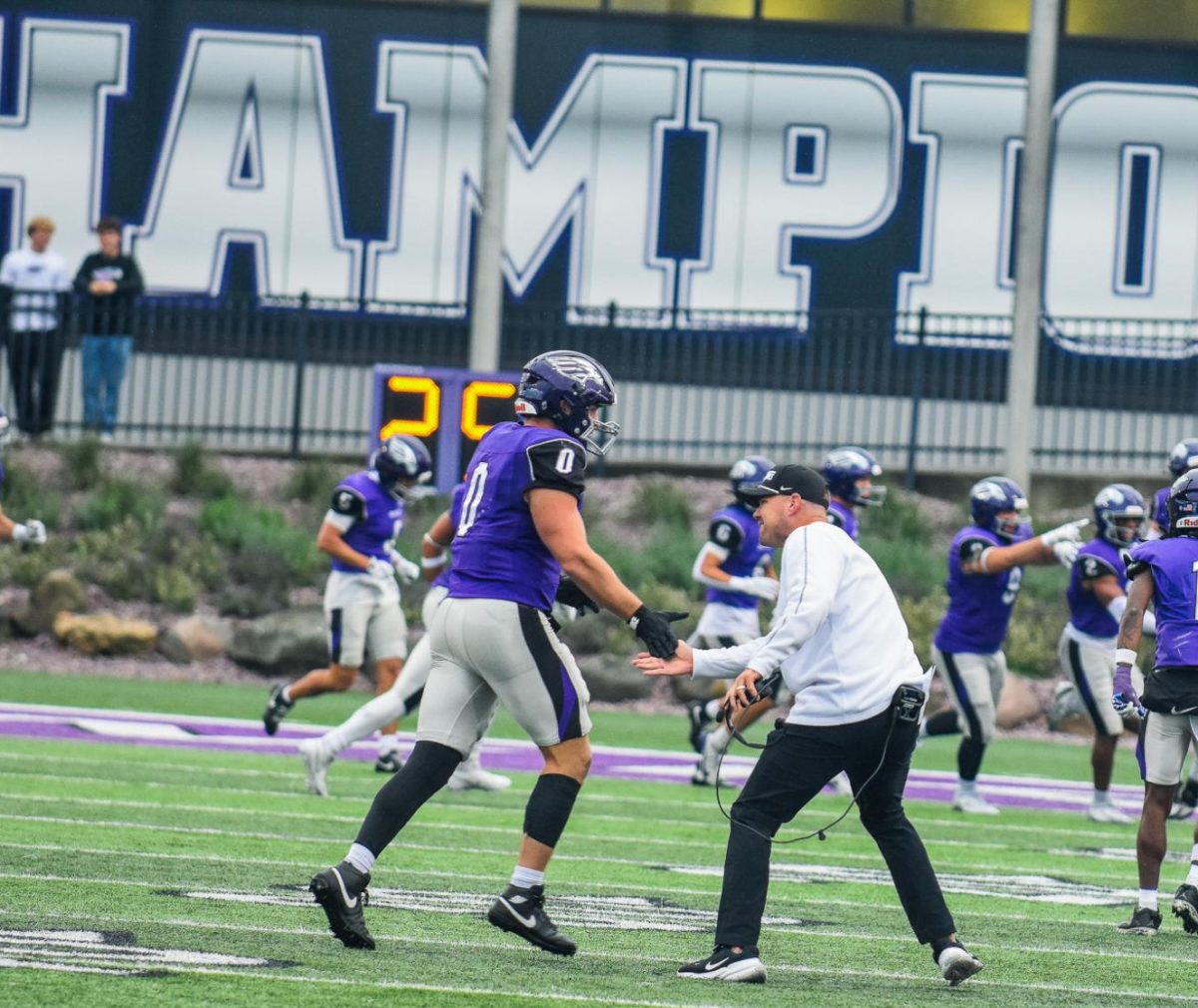 The UW-Whitewater head football coach Jace Rindahl congratulates junior defensive linesman Noah Moris on an outstanding performance against the conference match up against UW-Platteville at Perkins Stadium, Oct. 25, 2026. 