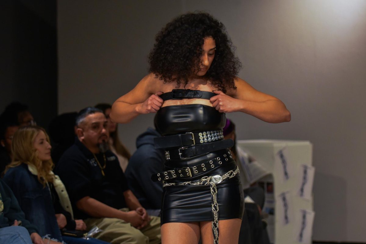  The UW-Whitewater Sevyn Fashion Modeling Troupe model poses at the halfway mark of the runaway in the Noir fashion show presented in the Crossman Gallery, April 4, 2026.