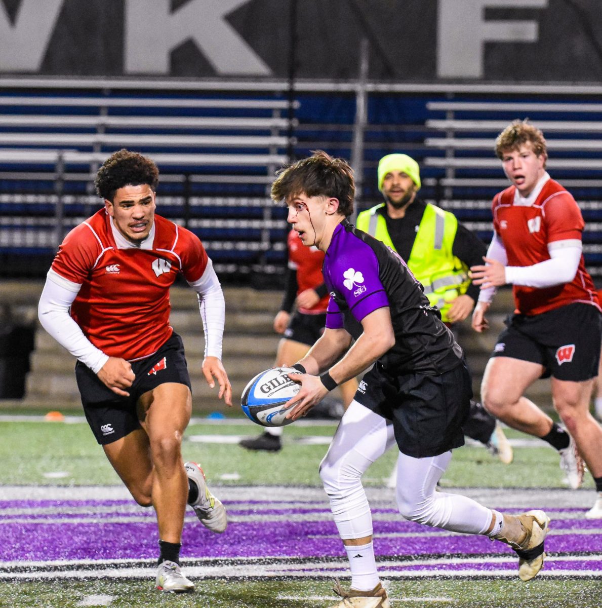 The UW-Whitewater Warhawk men’s club rugby junior Thomas Kuklinski races down the field to try to advance the ball against UW-Madison at Perkins Stadium, March 12, 2026. 