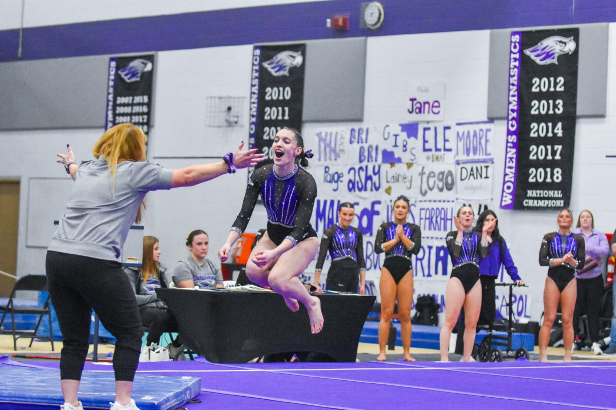The UW-Whitewater gymnastics freshman all-around Juliette Rider celebrates with head coach Jen Regan after competing in her floor routine against UW-Stout,  Feb 14, 2026 in the  Kris Russell Volleyball Arena. 